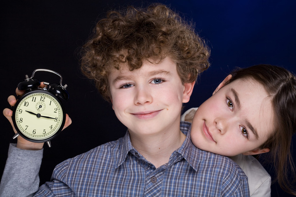 Young boy and girl with alarm clock - Foto, Imagen