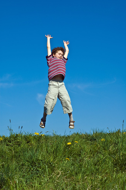 Boy jumping outdoors - Fotografie, Obrázek
