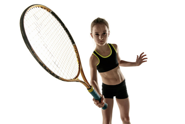 Little caucasian girl playing tennis isolated on white background - Foto, Imagen