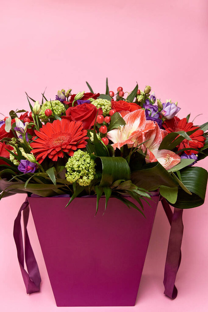 Beautiful bouquet of red and purple flowers on pastel pink background - Φωτογραφία, εικόνα