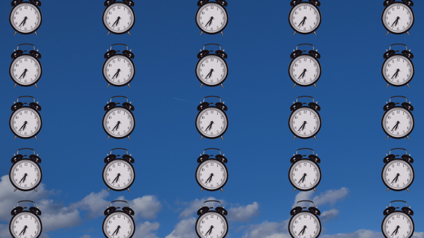 Time concept, footage with alarm clocks on cloudy sky background - Materiaali, video