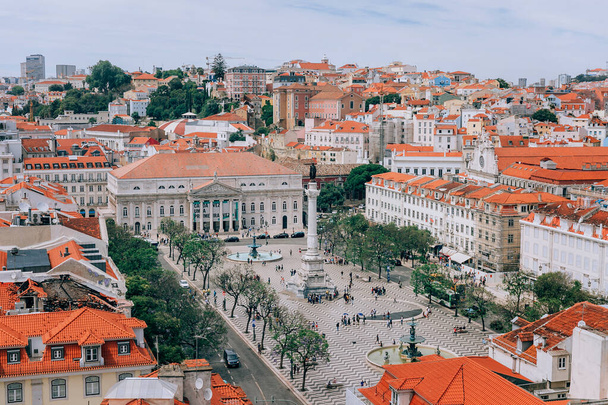 A large orange building. View of the Roscio square. Lisbon Portugal. View of the rooftops of Lisbon. Portugal - Photo, Image