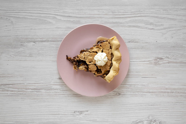 A slice of homemade Chocolate Walnut Derby Pie on a pink plate o - Photo, Image