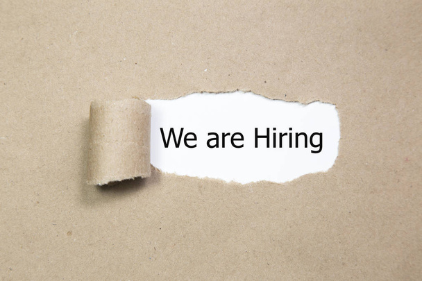 We're Hiring written under torn paper. Human resource concept, strategy, plan, planning. - Photo, Image