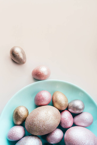 Colored chicken and quail eggs of pink, silver, golden and blue color  - Foto, imagen