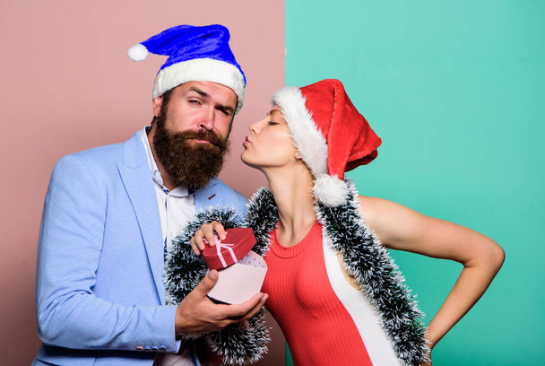 Office christmas party. Happy man and woman wear santa hats. Cheerful couple celebrate new year. Christmas party office. Giving gift. Festive mood. Boxing day. Secret Santa. Winter corporate party - Photo, image