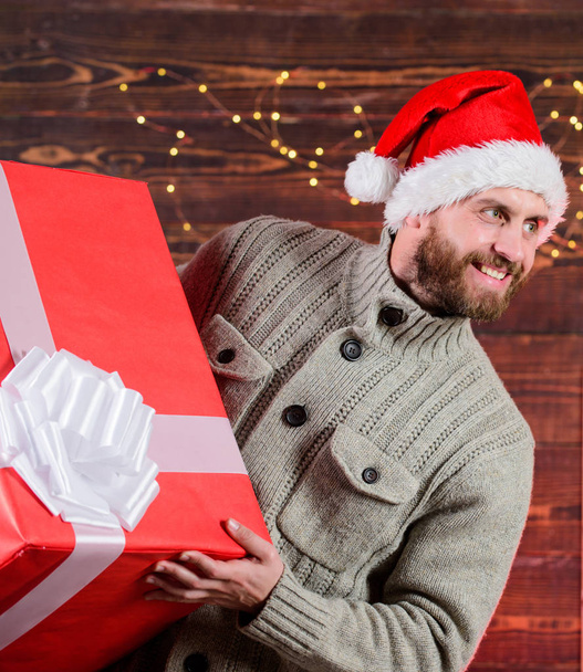 home gift delivery. happy man with beard santa hat. present for you. only my. advantageous offer of winter discounts. christmas shopping sales. what a surprise. new year gift. man hols huge gift - Photo, Image
