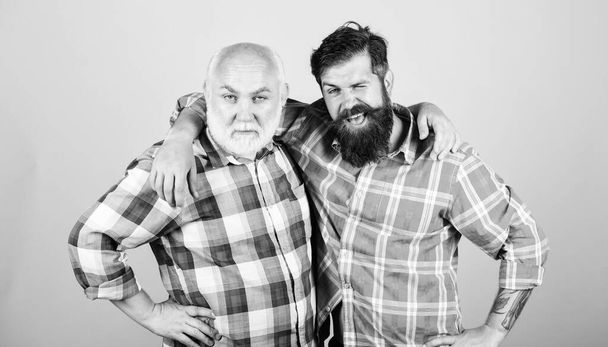 Hairdresser salon. Barbershop concept. Barber well groomed handsome mature man. Brutal barber with long beard. Men bearded hipster barber. Brutality and masculinity. Bearded friends. Father and son - Фото, изображение