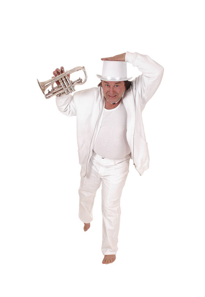 A trumpet player standing in a white outfit and hat - Photo, Image