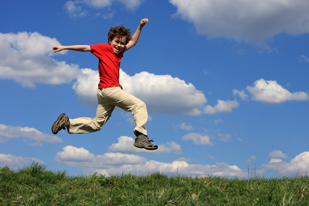 Boy jumping outdoors - 写真・画像