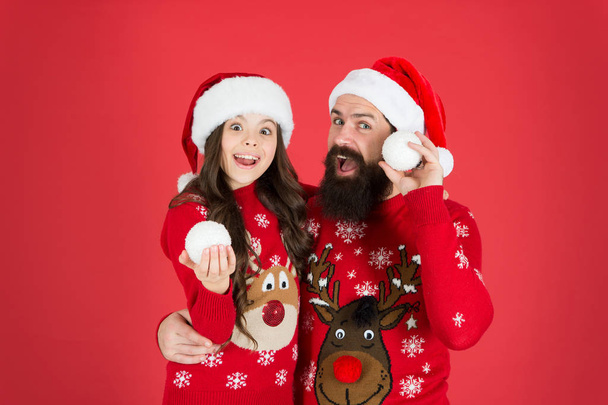We are family. family holiday fun. small girl and dad red background. merry christmas everyone. Greeting xmas tradition. happy family play snowballs in winter. father and daughter celebrate new year - Foto, Imagem
