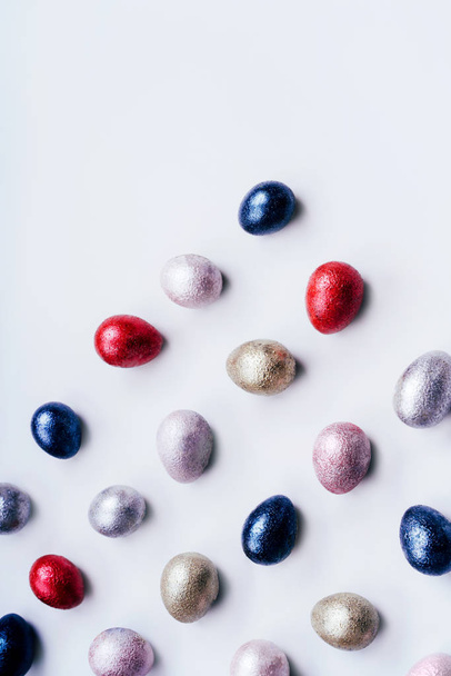 Colored chicken and quail eggs of pink, silver, golden and blue color  - 写真・画像