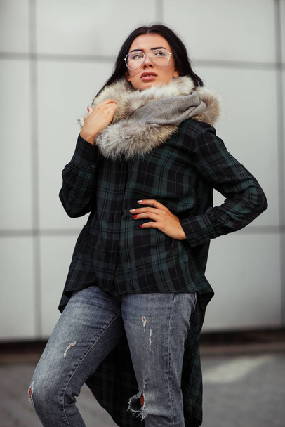 Outdoor close up fashion portrait of young beautiful confident woman wearing trendy shirt, white scarf and sunglasses Beautiful woman in luxury fur shawl. Advertising for sunglasses shop. Copy space. - 写真・画像