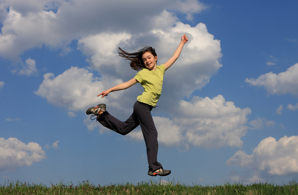 Girl jumping on green meadow - Fotó, kép