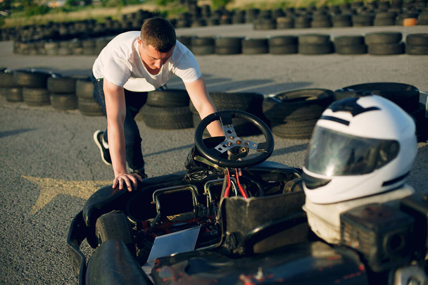 Handsome man in a karting with a car - Photo, image