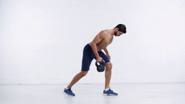 sportsman exercising with weight on white background - Footage, Video