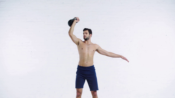 sportsman exercising with weight on white background - Metraje, vídeo