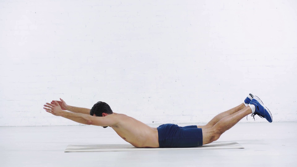 sportsman doing downward abs on white background - Metraje, vídeo