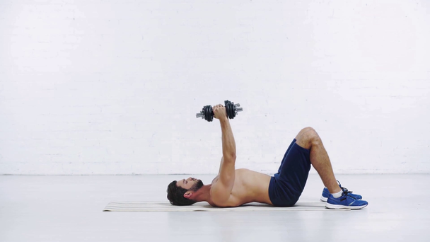 sportsman exercising with dumbbells on white background - Metraje, vídeo