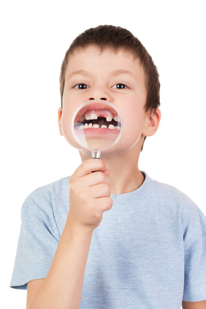 boy shows through a magnifying glass lost tooth - Photo, Image