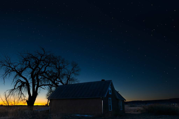 Beautiful scenery of a house under the magical night sky - Фото, изображение