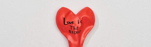 Top view of balloon with love is answer lettering on grey background, panoramic shot - Fotó, kép