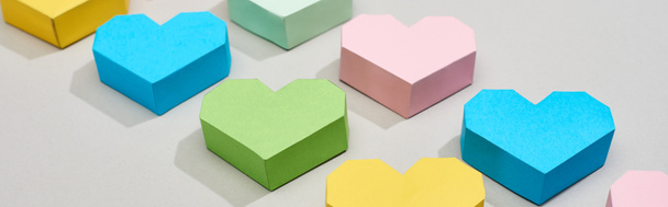 Panoramic shot of colorful paper hearts on grey background - Fotó, kép