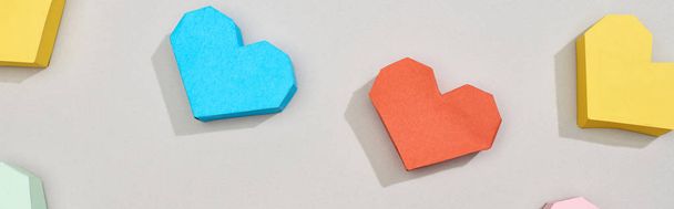 Top view of decorative heart shaped papers on grey background, panoramic shot - Фото, зображення