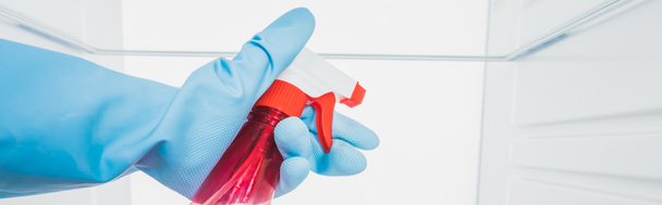 Cropped view of woman in rubber glove cleaning fridge with detergent isolated on white, panoramic shot - Valokuva, kuva