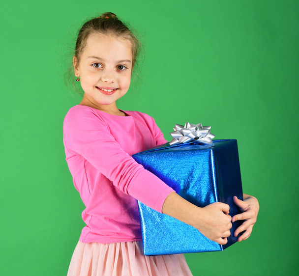 Girl with wrapped gift box for holiday. Birthday surprise concept. - Foto, imagen