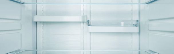 Panoramic shot of clean shelves of refrigerator - Photo, Image
