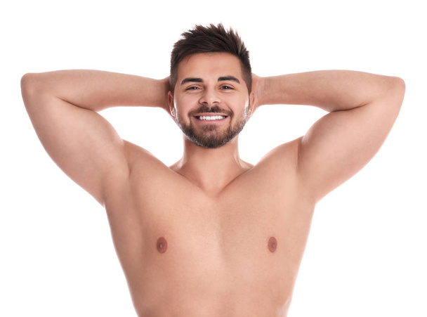 Young man showing hairless armpits after epilation procedure on white background - Foto, Imagem