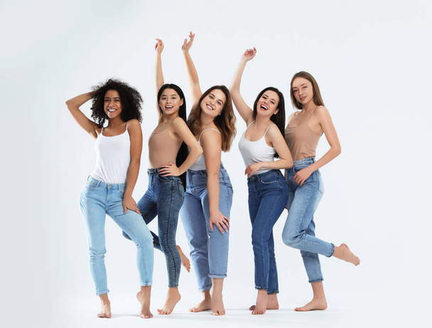 Group of women with different body types on light background - Foto, immagini