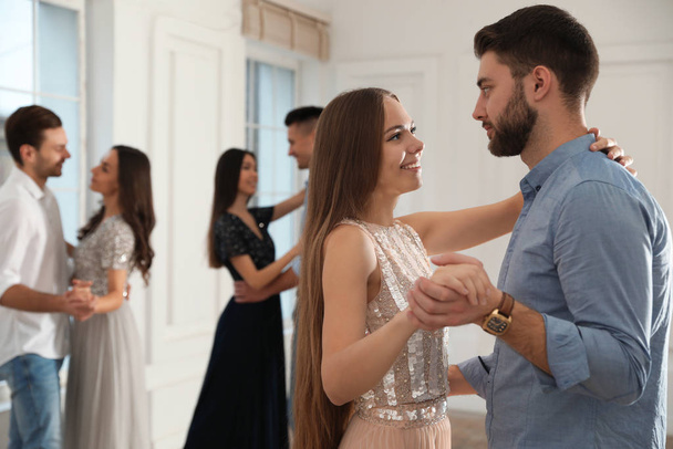 Lovely young couple dancing together at party - Fotografie, Obrázek