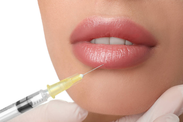 Woman getting lip injection on white background, closeup - Foto, Imagem