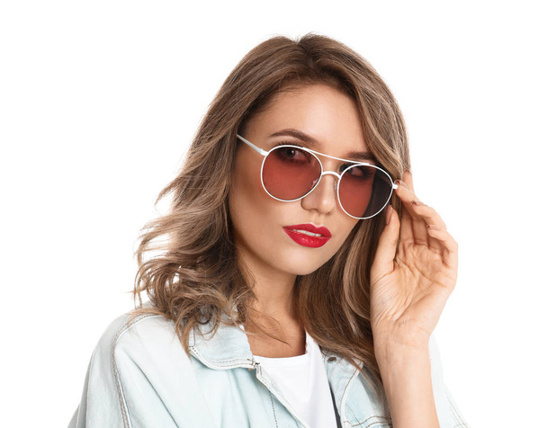 Young woman wearing stylish sunglasses on white background - Fotoğraf, Görsel