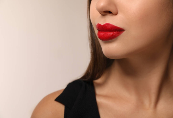 Beautiful woman with red lipstick on light background, closeup. Space for text - Fotografie, Obrázek
