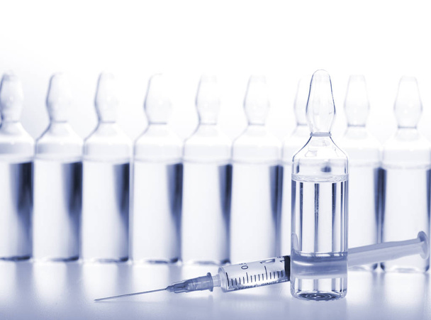 Glass medicine ampoules and Syringe on white background - Фото, зображення