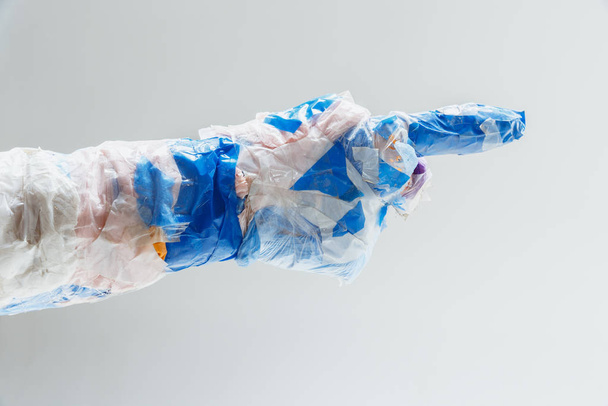Big plastic hand made of garbage isolated on white studio background - Zdjęcie, obraz
