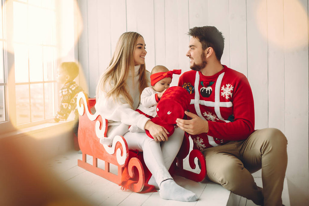 Family sitting at home with christmas gifts - 写真・画像