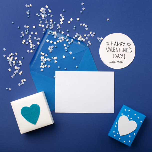 Blue envelop, gifts and white hearts on classic blue  - Photo, Image