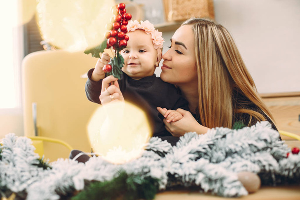 Mother with cute daughter in a christmas decorations - Fotoğraf, Görsel