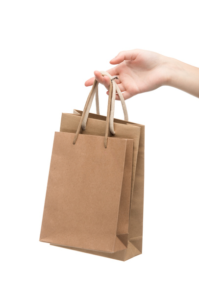 cropped view of woman holding shopping bags isolated on white  - Fotoğraf, Görsel