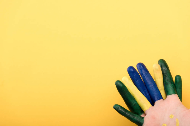 cropped view of woman with colorful fingers isolated on yellow  - Photo, Image
