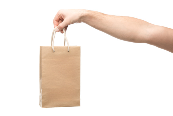 cropped view of man holding shopping bag isolated on white  - Foto, Bild