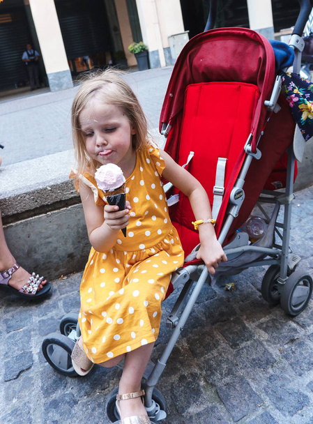 little girl with a basket of ice cream in the city - Photo, Image