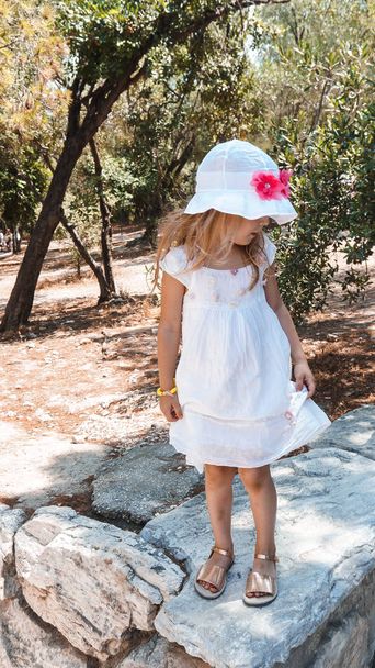 little girl in a white dress in the park - Photo, Image