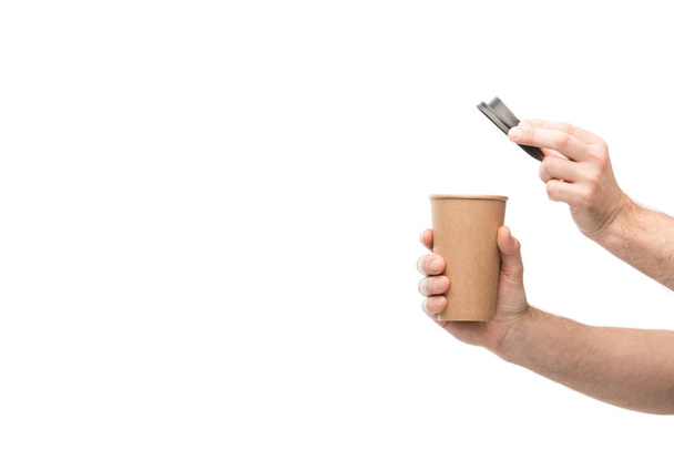 cropped view of man holding paper cup isolated on white - Foto, Bild