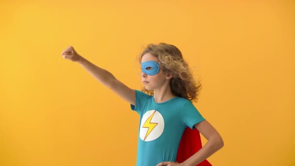 Young girl wants to become a super hero. Teenager dreams of becoming a superhero. Imagination and motivation concept. Slow motion - Video