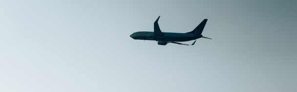 Low angle view of plane taking off in sky, panoramic shot - Photo, image